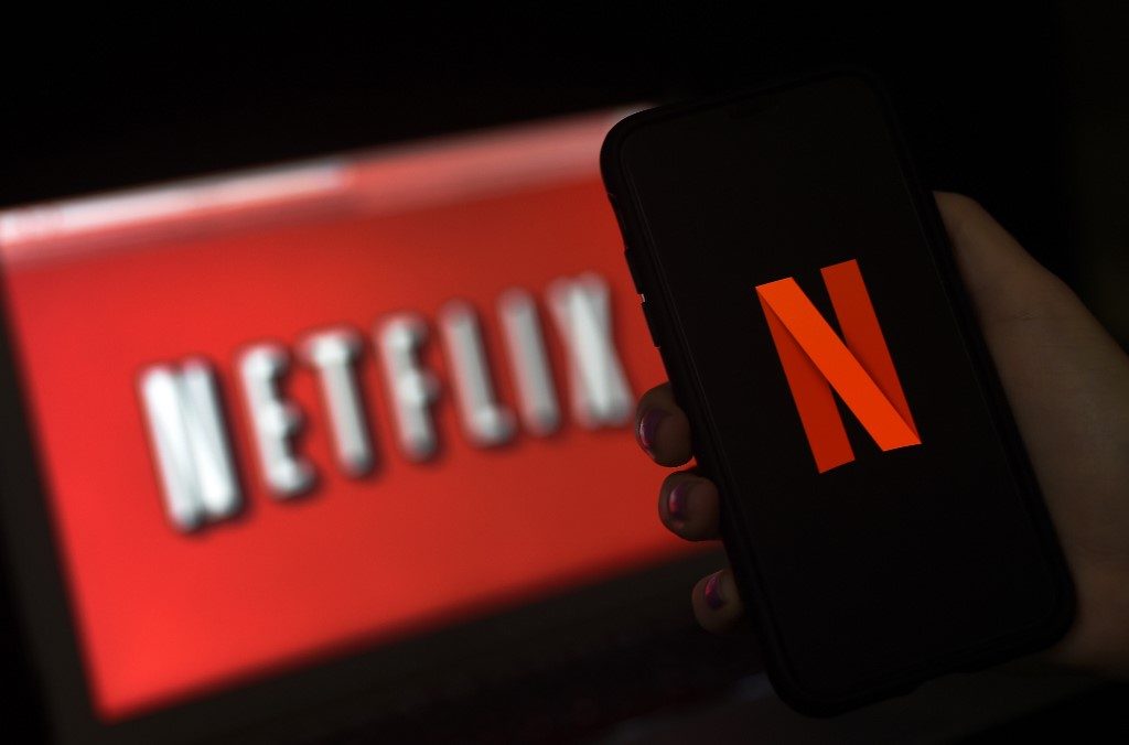 Netflix reports slowing subscriber growth; shares slide