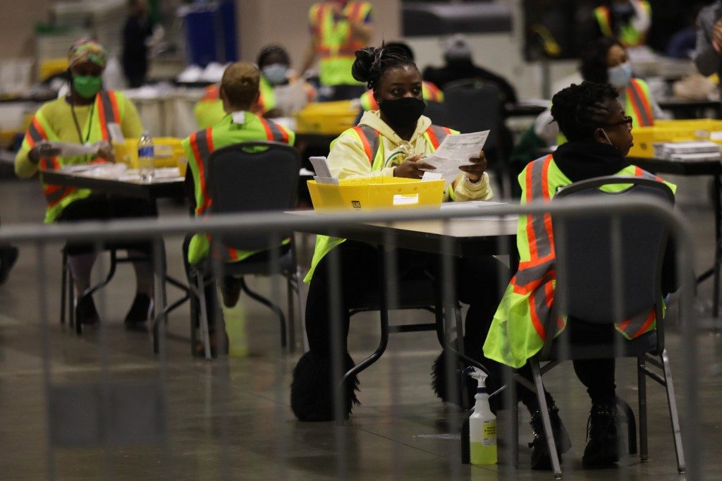Gloved and masked, US vote counters keep focused on historic task