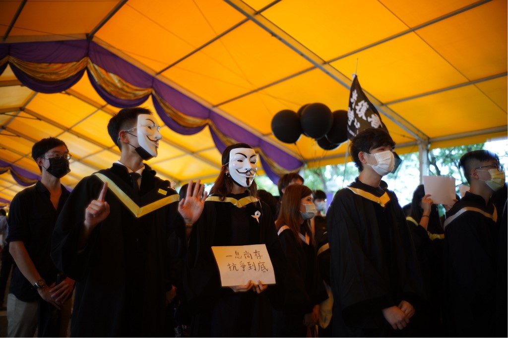 Graduating Hong Kong students display banned pro-democracy slogans