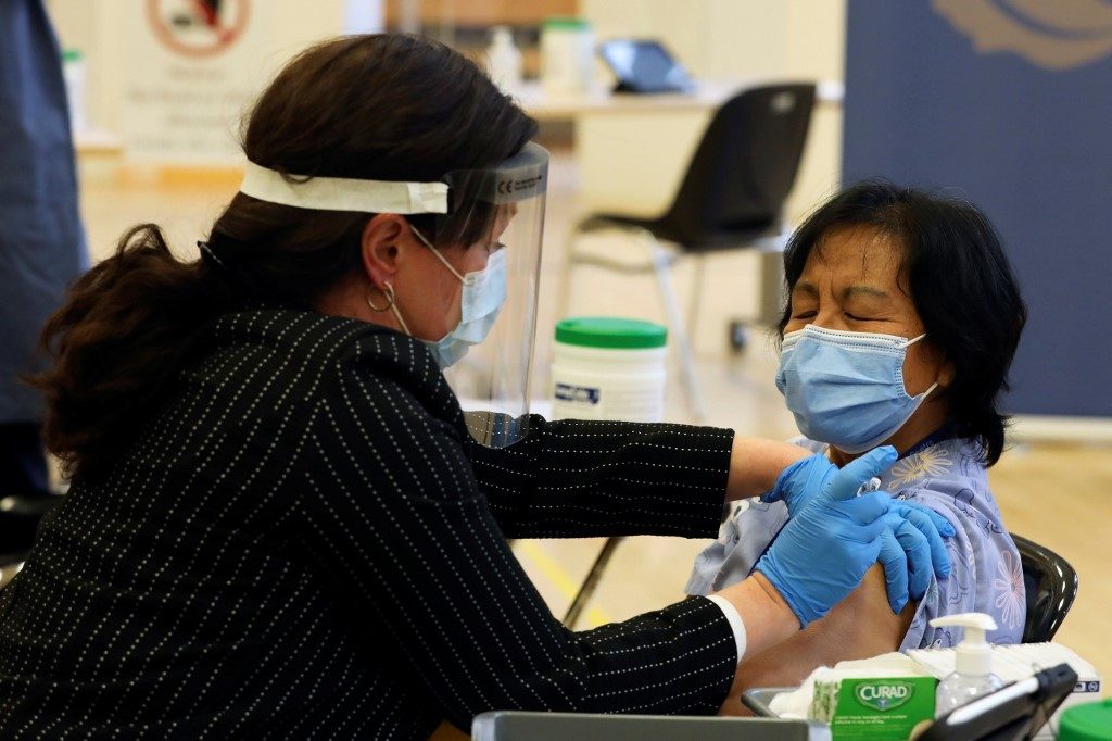 In Canada, Filipino health worker among first to get  historic COVID-19 vaccine