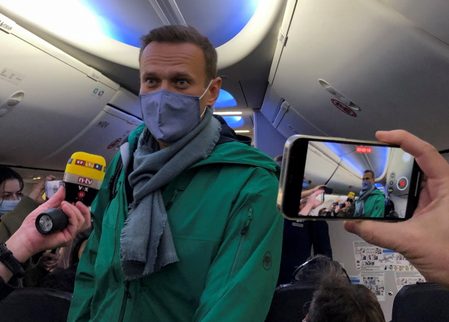 ‘Are you detaining me?’ Navalny flies home, and straight into trouble