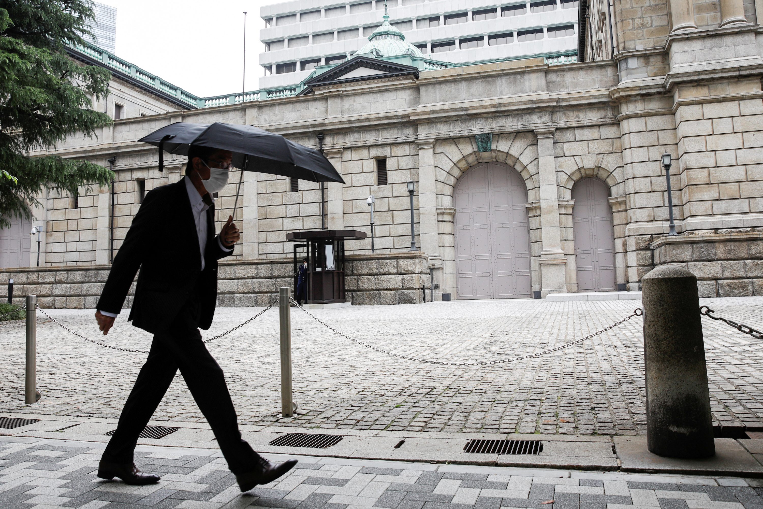 Bank of Japan lifts growth forecast, saves ammunition as virus risks linger