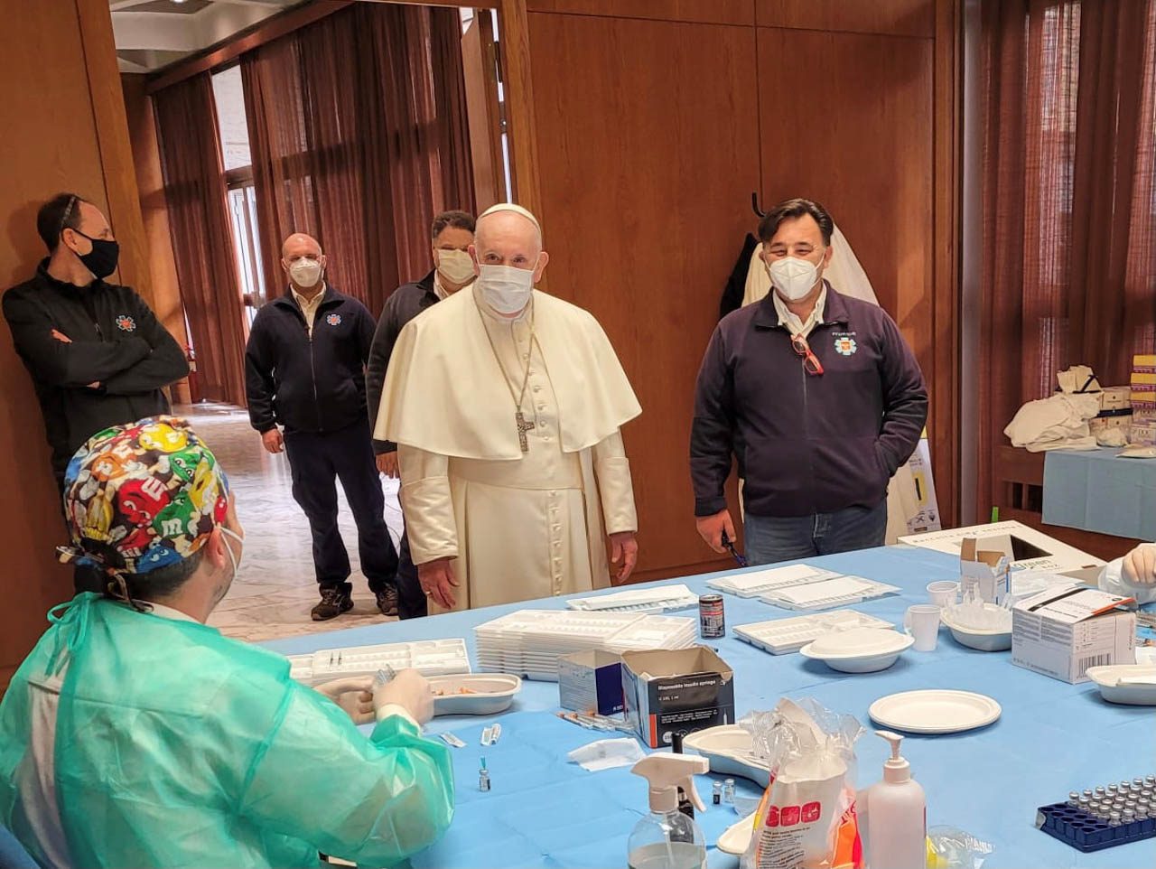 Pope makes surprise visit to homeless getting COVID-19 vaccine in Vatican