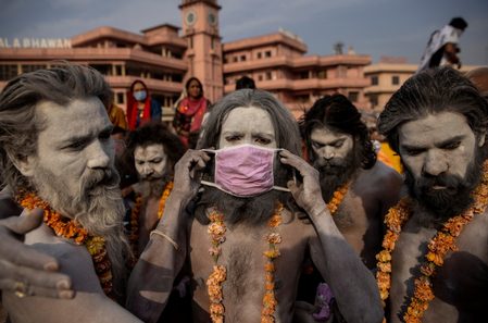India’s daily virus infections are world’s highest but crowds gather for festival