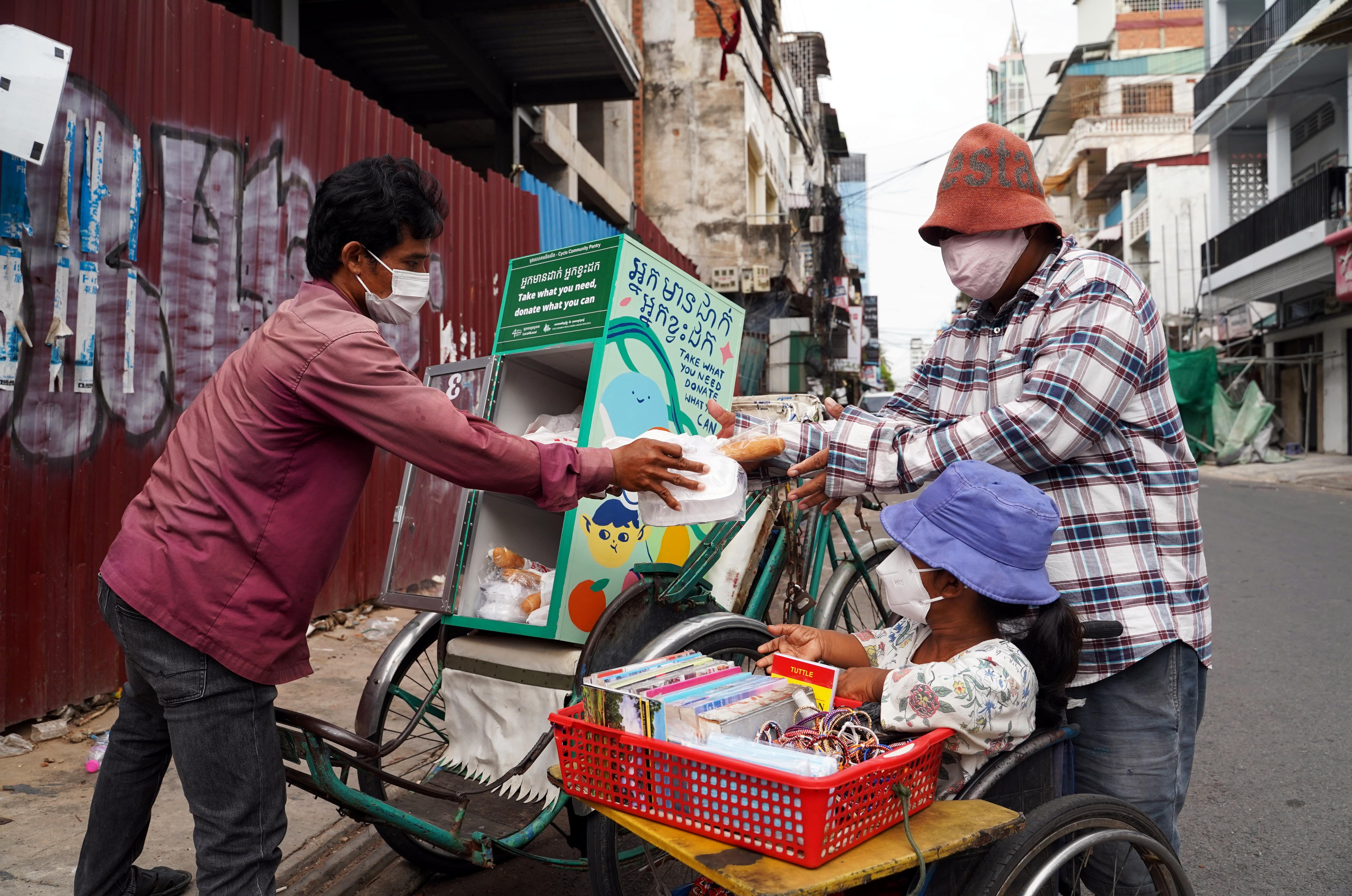 Cambodia’s cyclos bring meals on three wheels to virus-hit Phnom Penh
