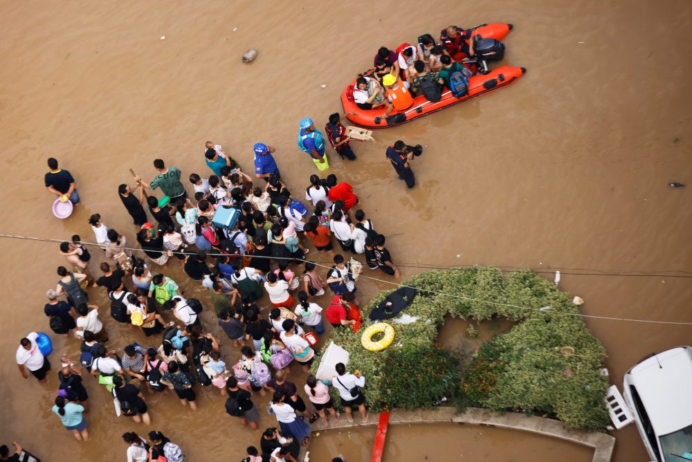 China evacuates tens of thousands as storms spread north