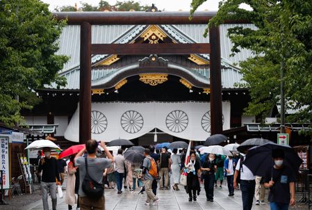 Japan’s Suga pledges not to wage war again as ministers visit controversial shrine