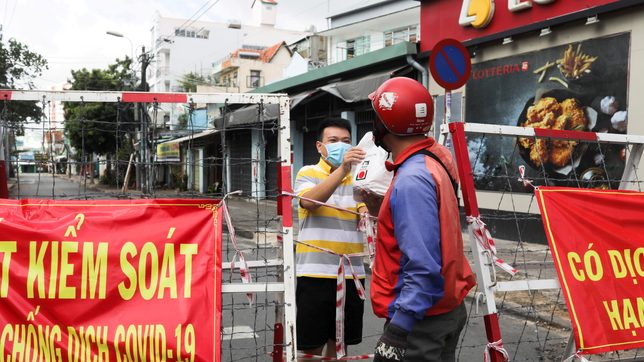 Workers try to flee Vietnam’s biggest city as coronavirus crisis worsens