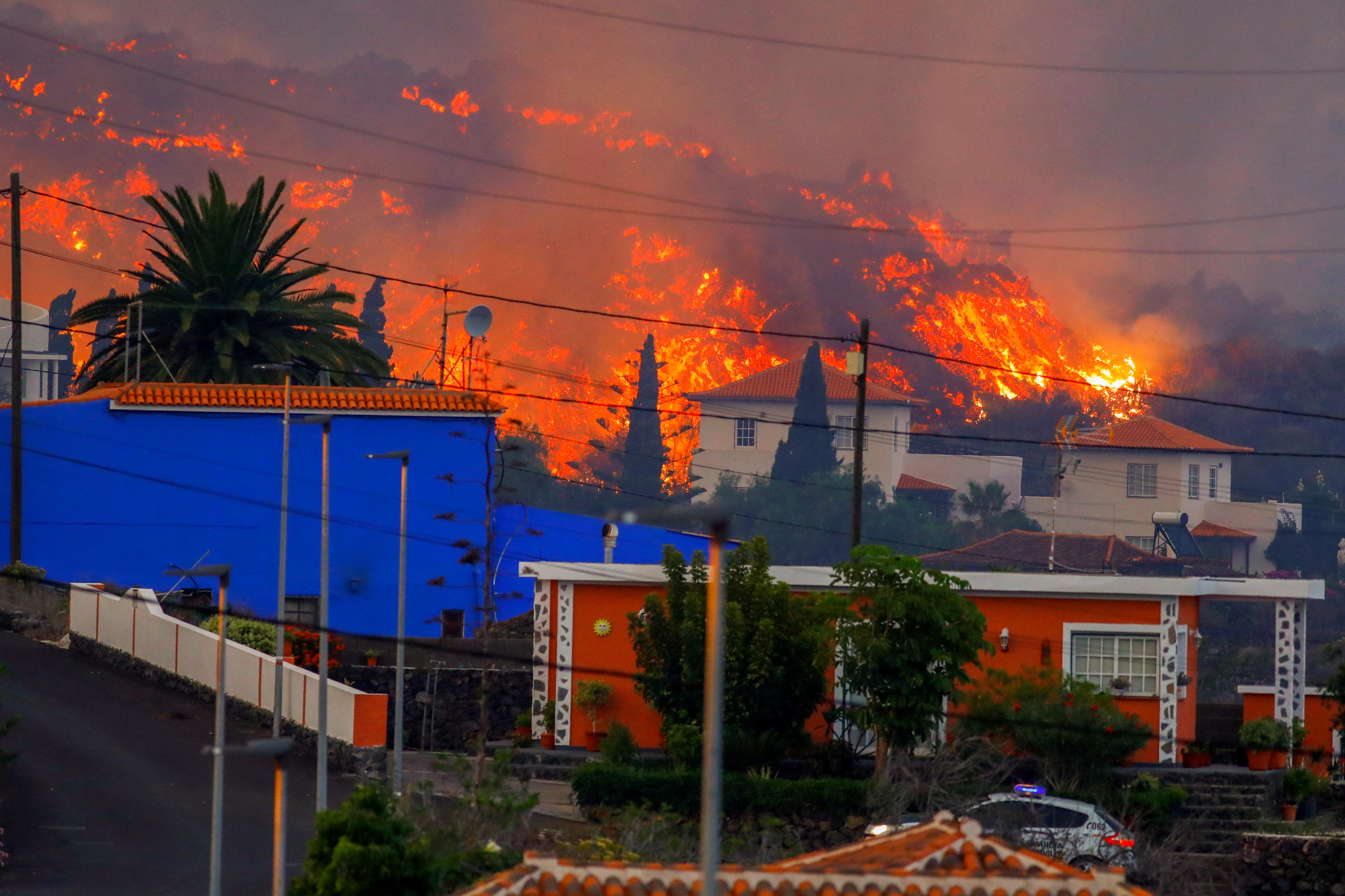 Thousands flee as lava spewing from volcano on Spain’s La Palma island destroys houses