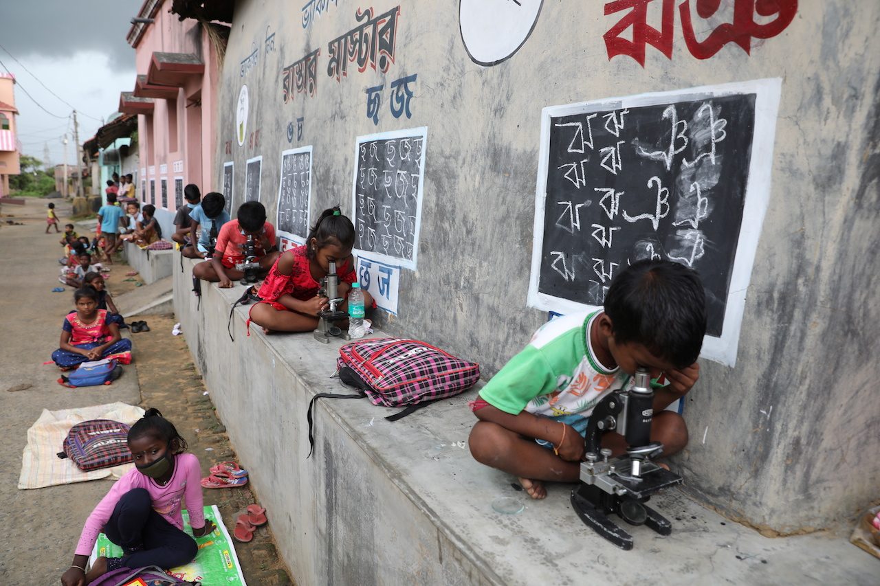 In remote Indian village, teacher turns walls into blackboards to close school gap