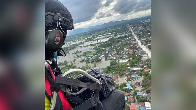 Thai volunteer soars high dropping supplies to flood victims