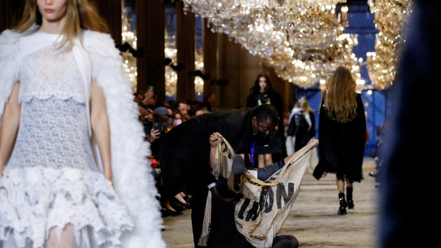 Climate change activist storms Louis Vuitton show in Paris