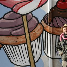 Street artist battles racism by turning swastikas into cupcakes