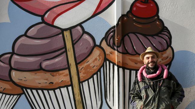Street artist battles racism by turning swastikas into cupcakes