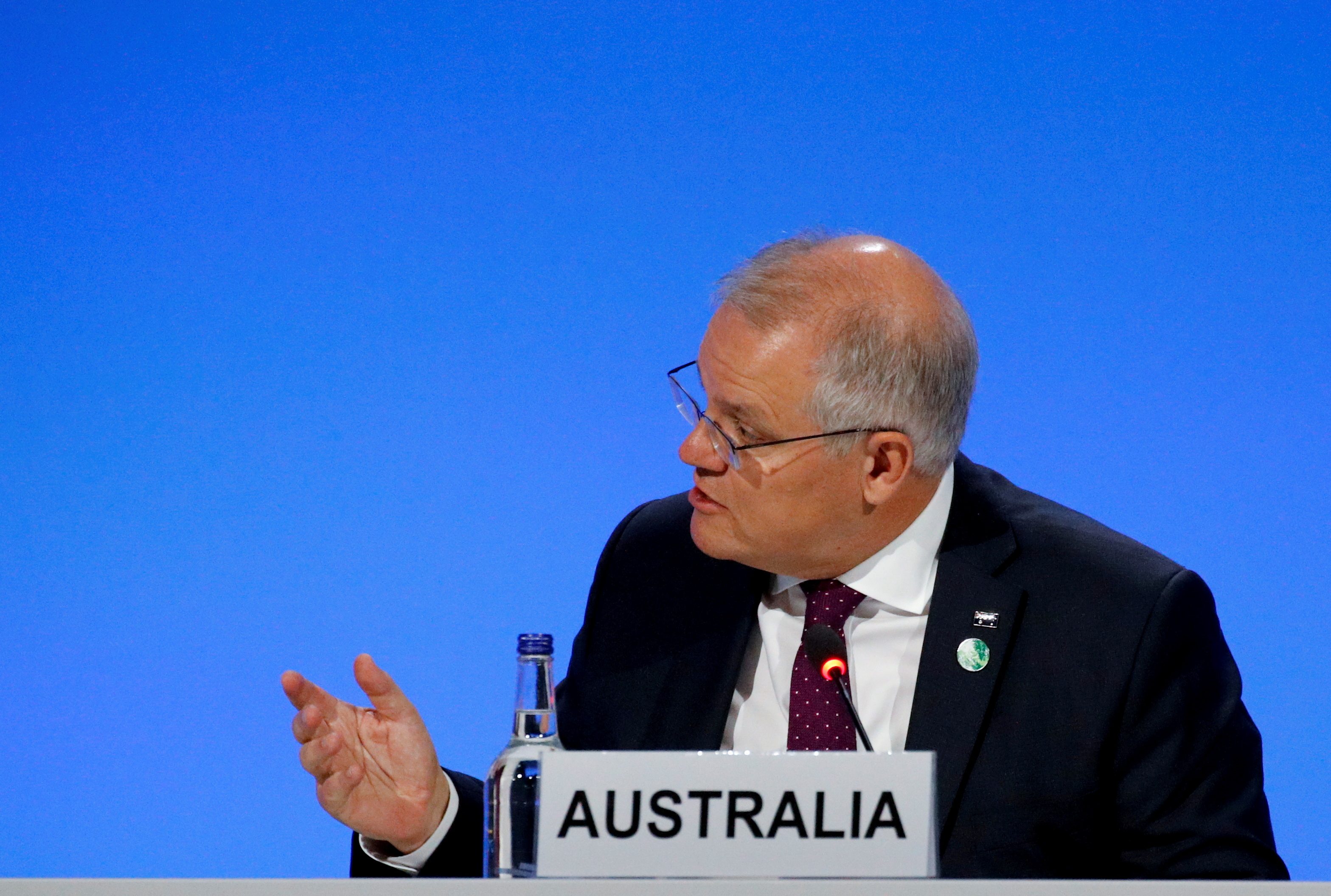 Australia PM, criticized on climate, urges firms to curb costs