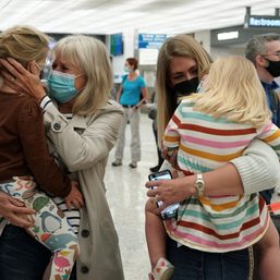 Families reunite in US with tears, balloons as COVID-19 travel ban ends