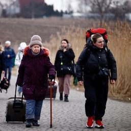 Clutching plastic bags and suitcases, Ukrainians flee to safety abroad