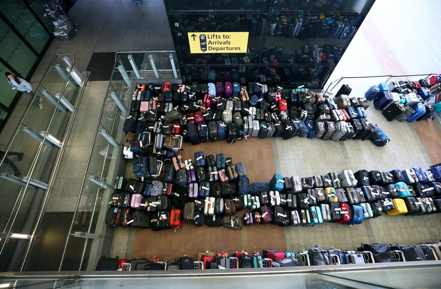 Luggage piles join long airport lines in fresh woes for travel