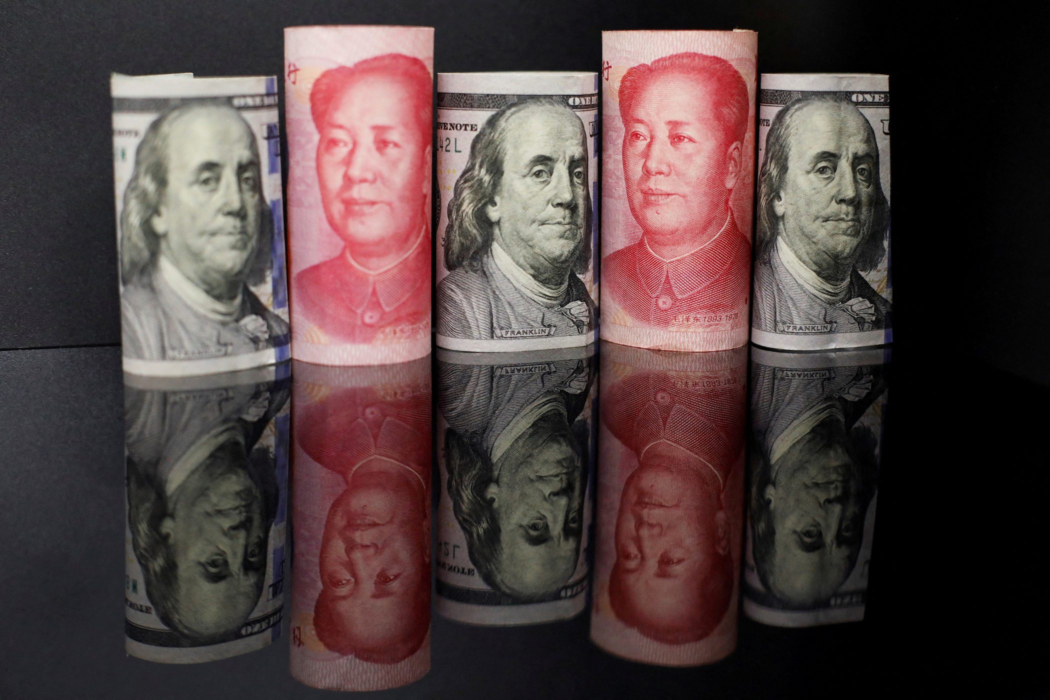 Chinese companies hang onto dollars, hedge to prepare for volatile yuan