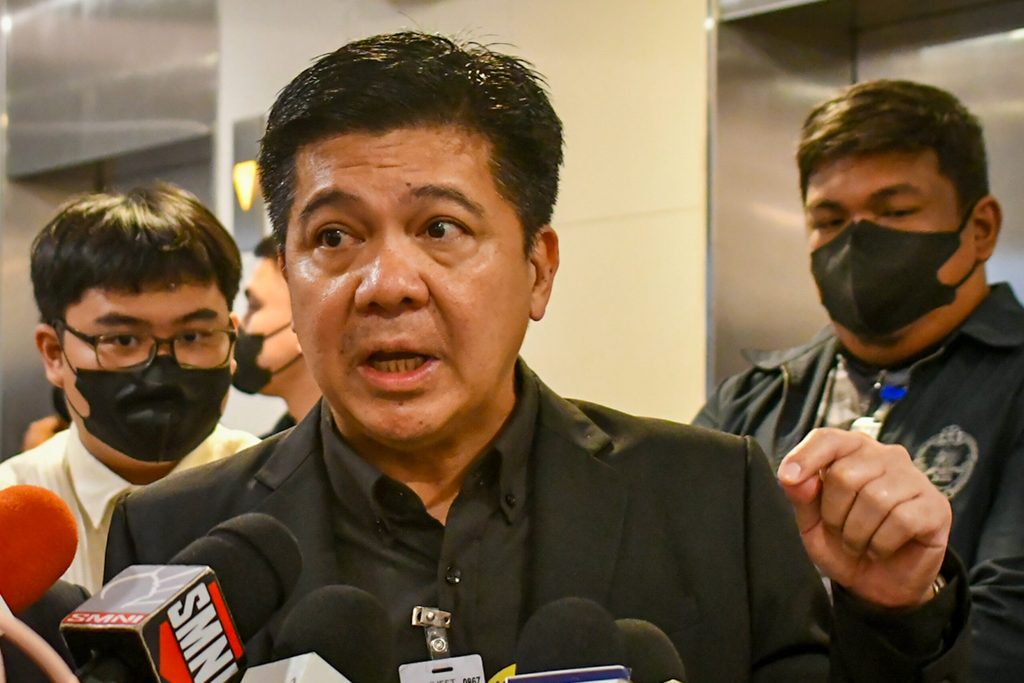 Ferdinand Topacio and Mike Defensor at the NBI