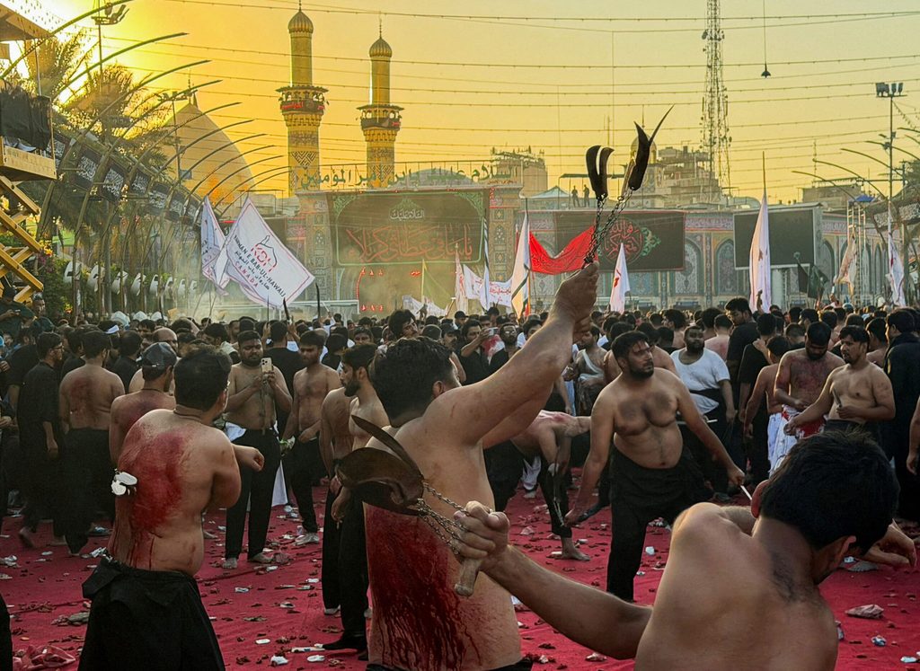 Shi'ite Muslims gash their backs with blades as they commemorate Ashura, the holiest day on the Shi'ite Muslim calendar, between the Imam Hussein and Imam Abbas shrines in Karbala