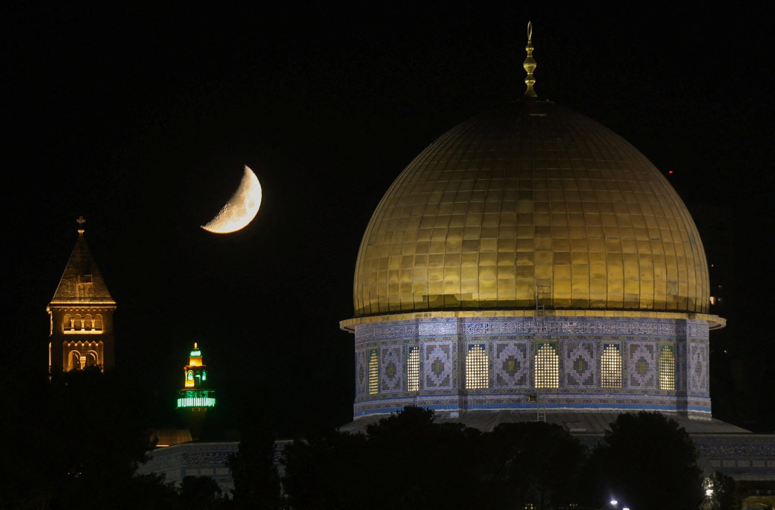 The moon rises over the Dome of the Rock in Jerusalem's Old City