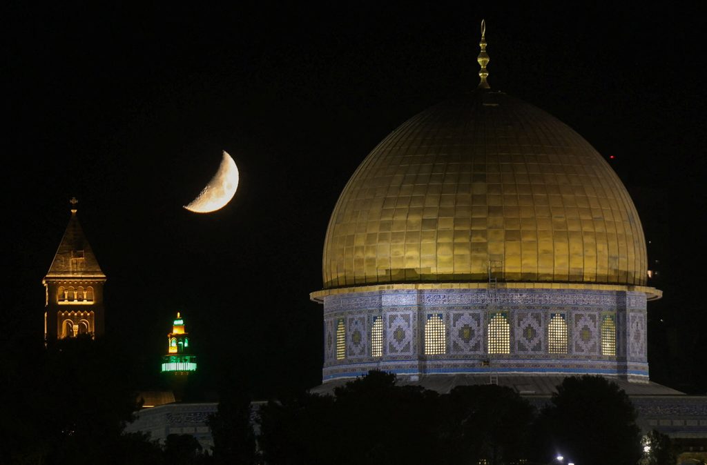 The moon rises over the Dome of the Rock in Jerusalem's Old City