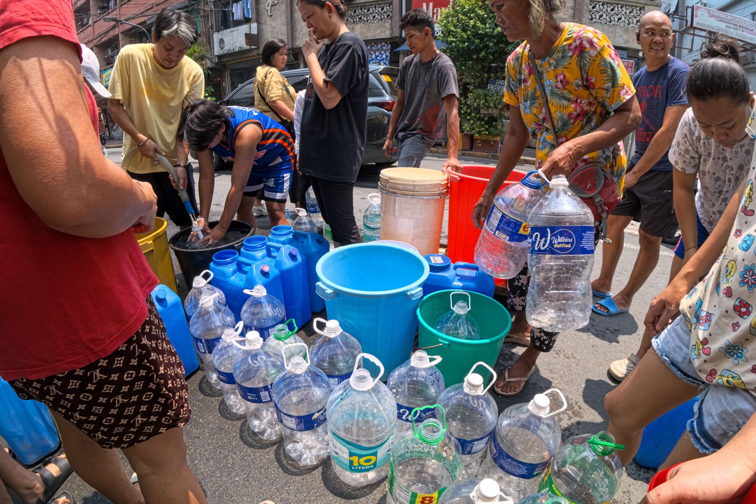 Residents line up for water after service interruption
