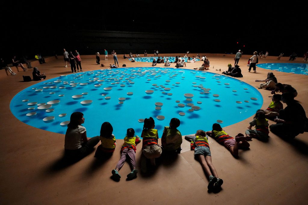 Schoolchildren observe the "clinamen" exhibit by French artist Celeste Boursier-Mougenot at Park Avenue Armory in New York City