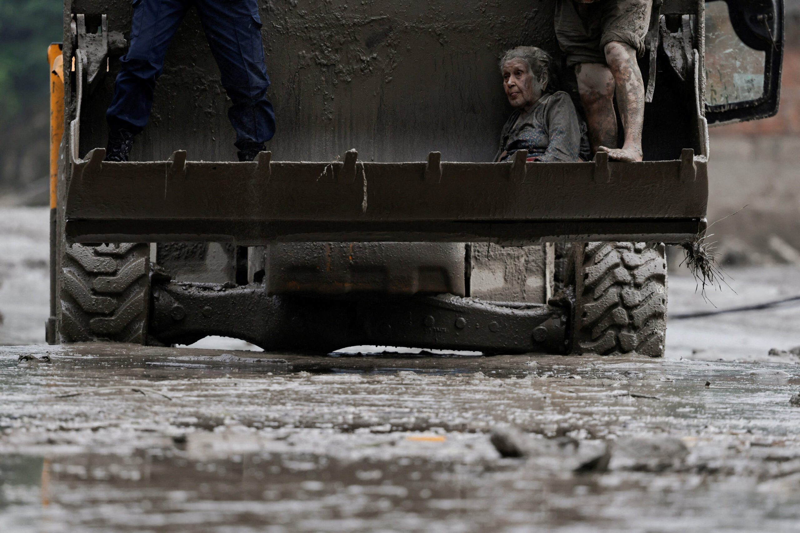 A survivor is transported to a safer place in heavy machinery following a flash flood at Trishuli, Nepal