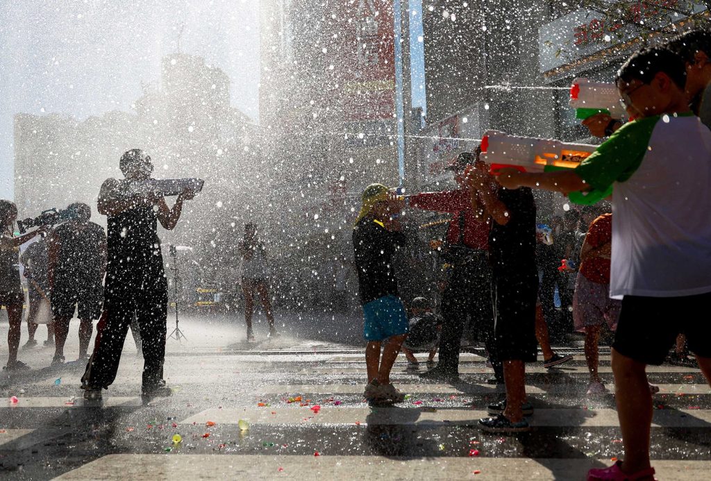 Water gun fight turns street into summer escape during heatwave in Seoul