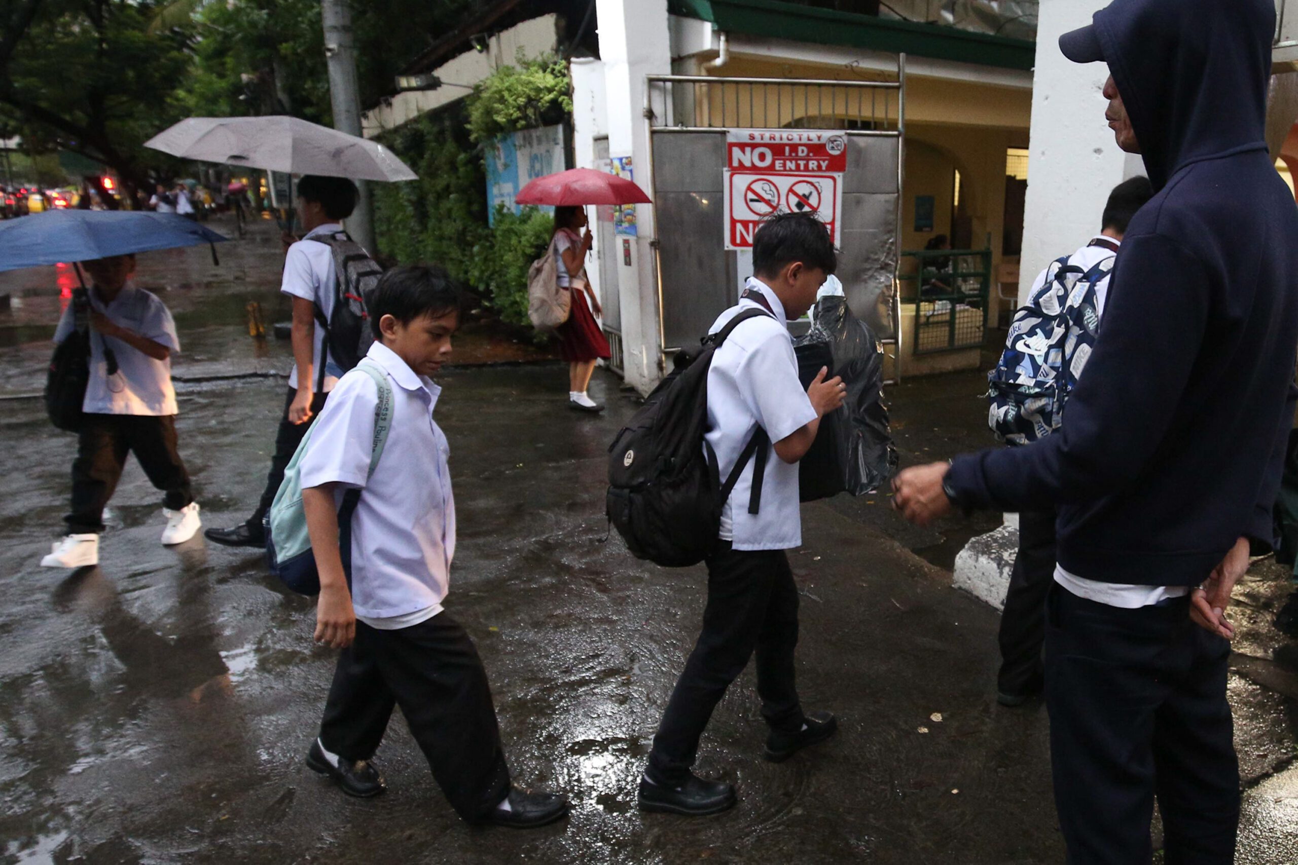 Students caught in the rain while on their way to school