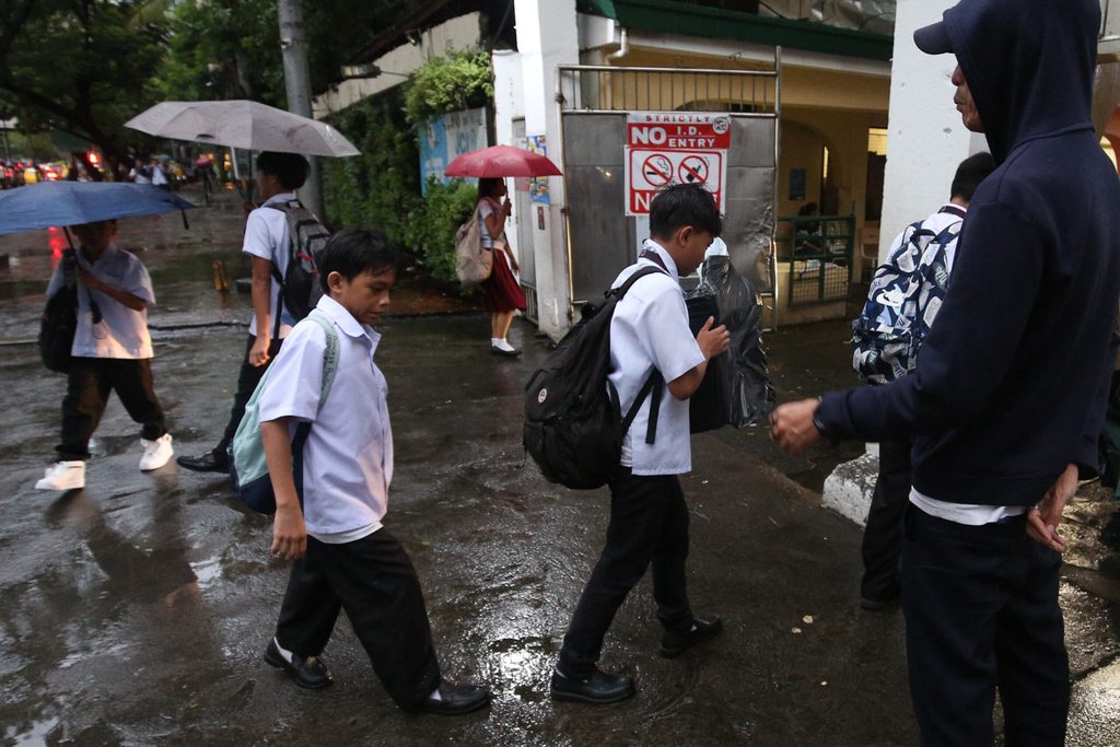 Students caught in the rain while on their way to school
