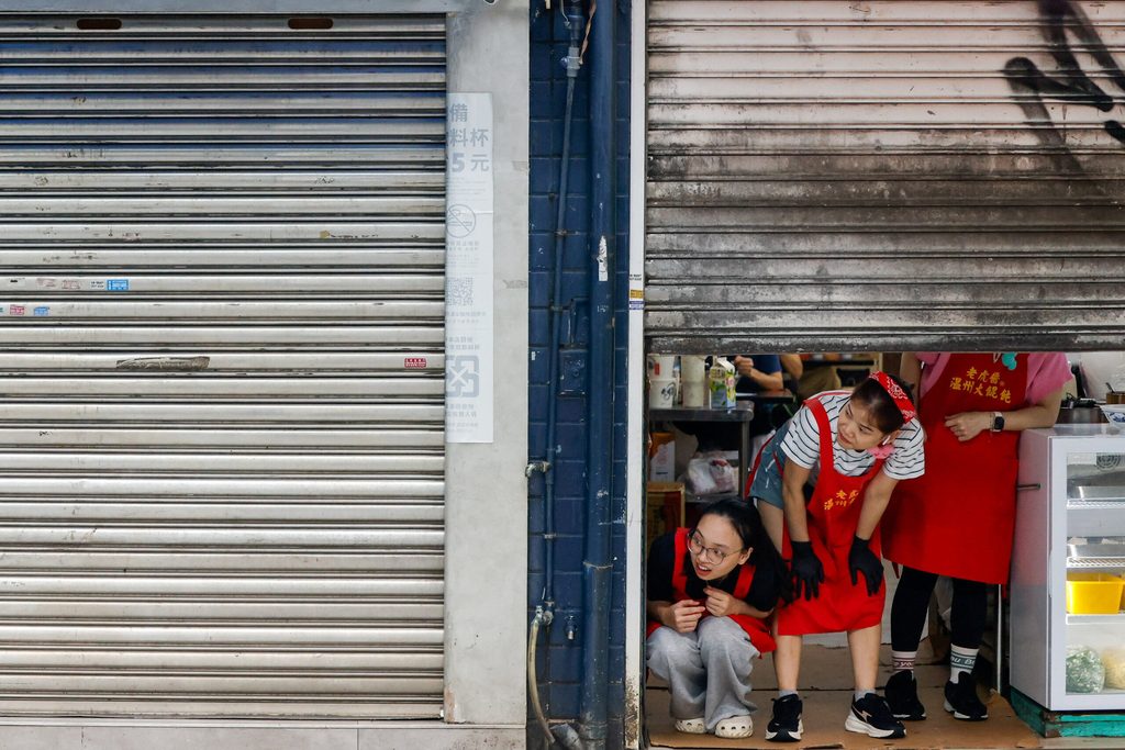 Restaurant staff take shelter indoors during an Urban Resilience air-defense drill held alongside the annual Han Kuang military exercises in Taipei