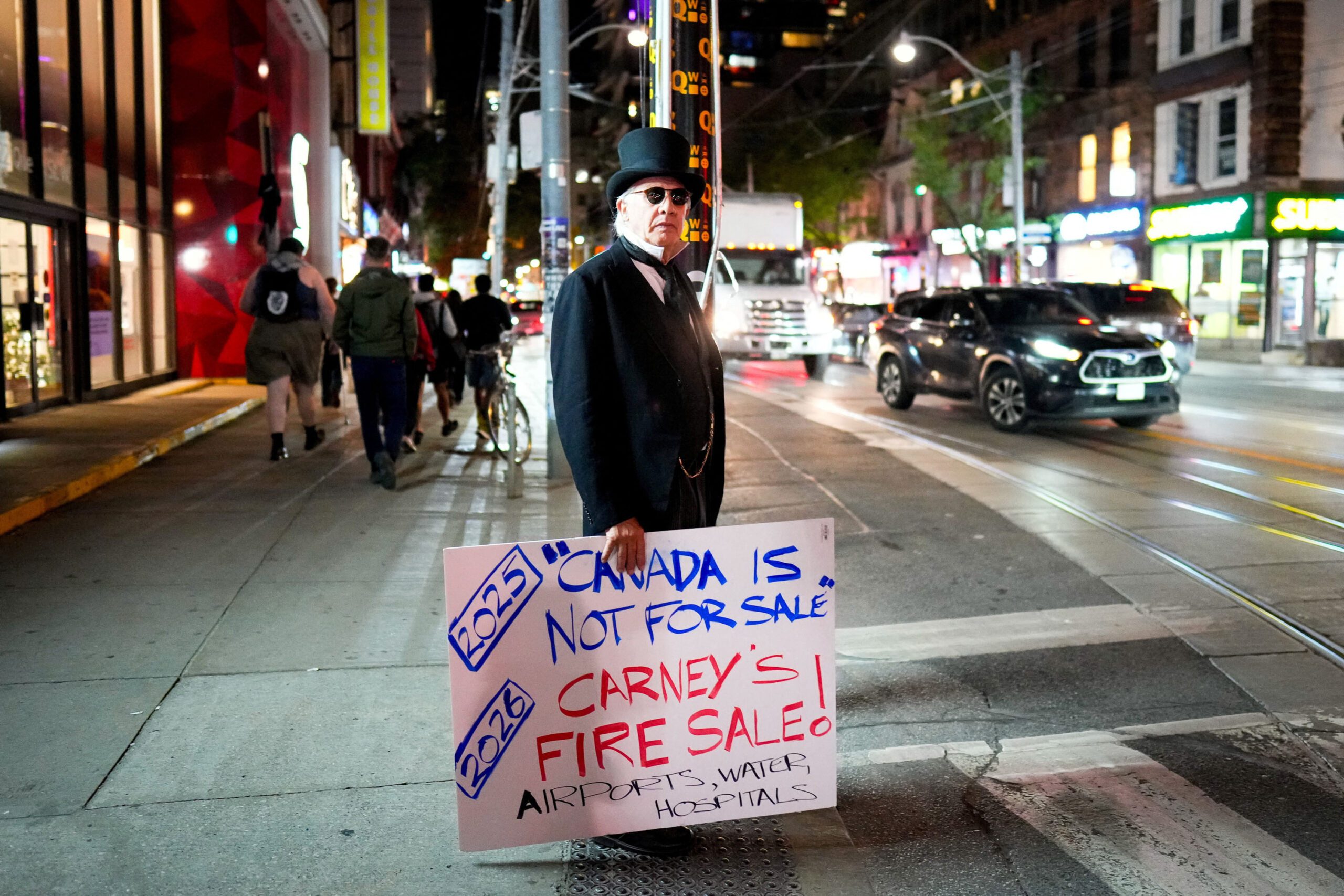 People protest on the day of the opening gala dinner of the Canada Investment Summit