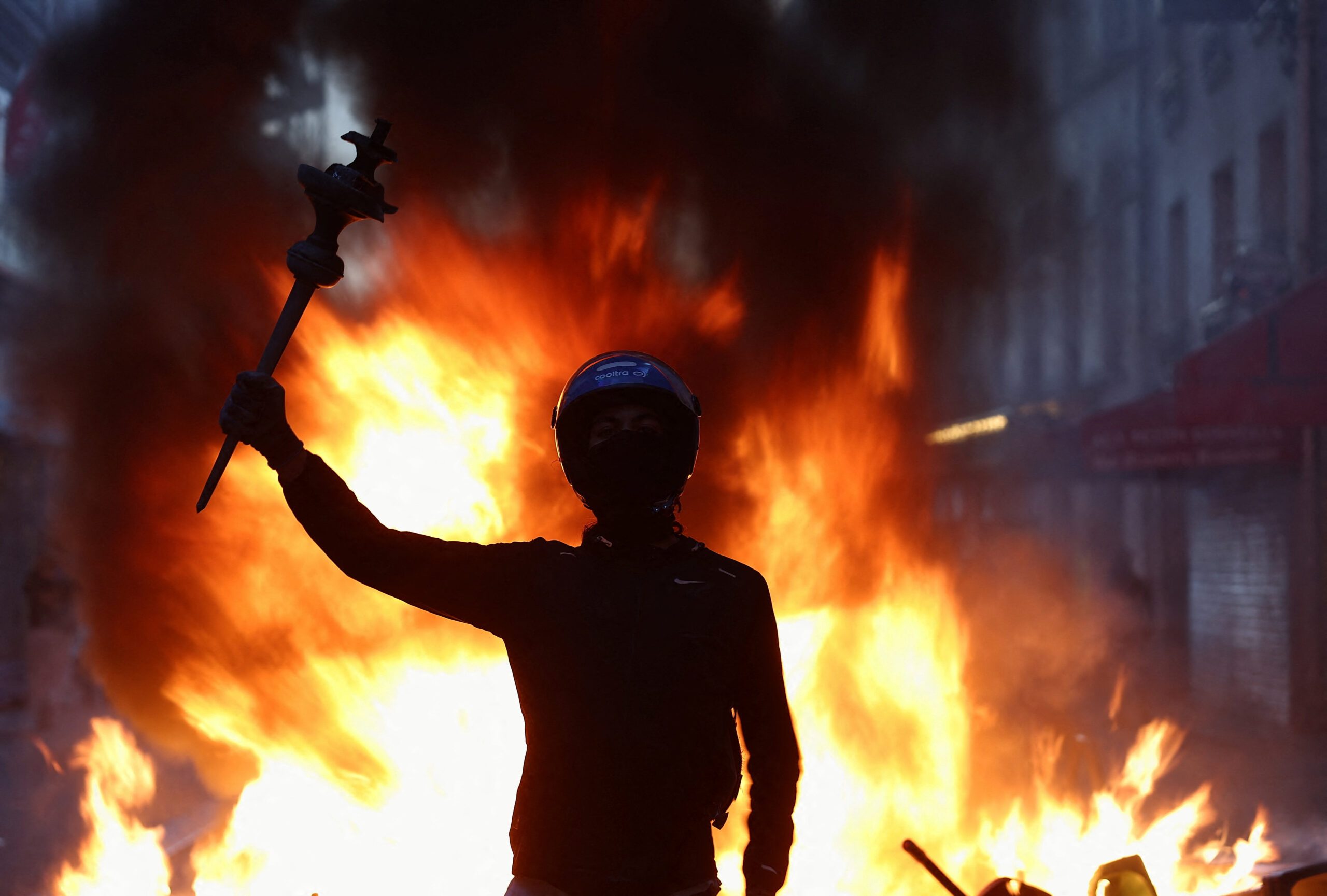 France counts the cost of worst unrest in years; Macron urges calm