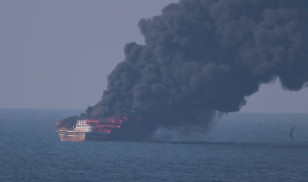 Smoke rises from a burning vessel, following what the US Central Command said was a strike on an Iranian-affiliated dhow, at a location given as the Gulf of Oman