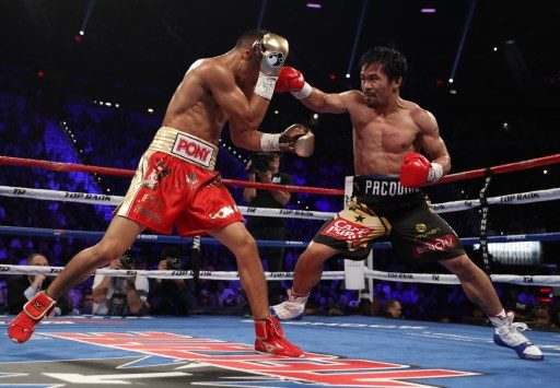 ATTACK. Manny Pacquiao of the Philippines throws a right to the head of Jessie Vargas during their WBO welterweight championship fight at the Thomas & Mack Center on November 5, 2016 in Las Vegas, Nevada. Christian Petersen/Getty Images/AFP  