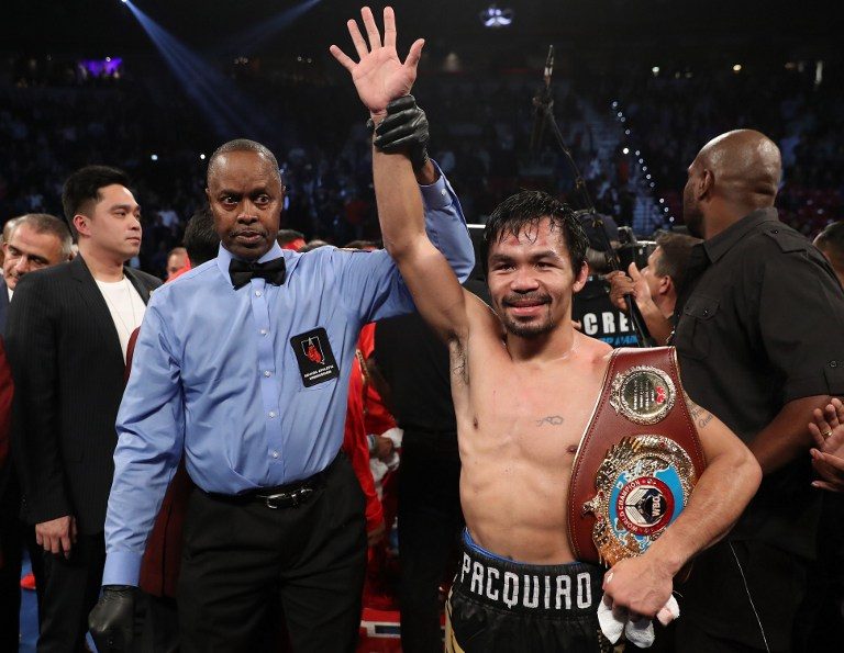 CHAMP. Manny Pacquiao poses after dethroning Jessie Vargas to reclaim the WBO welterweight championship. Christian File photo by Petersen/Getty Images/AFP  