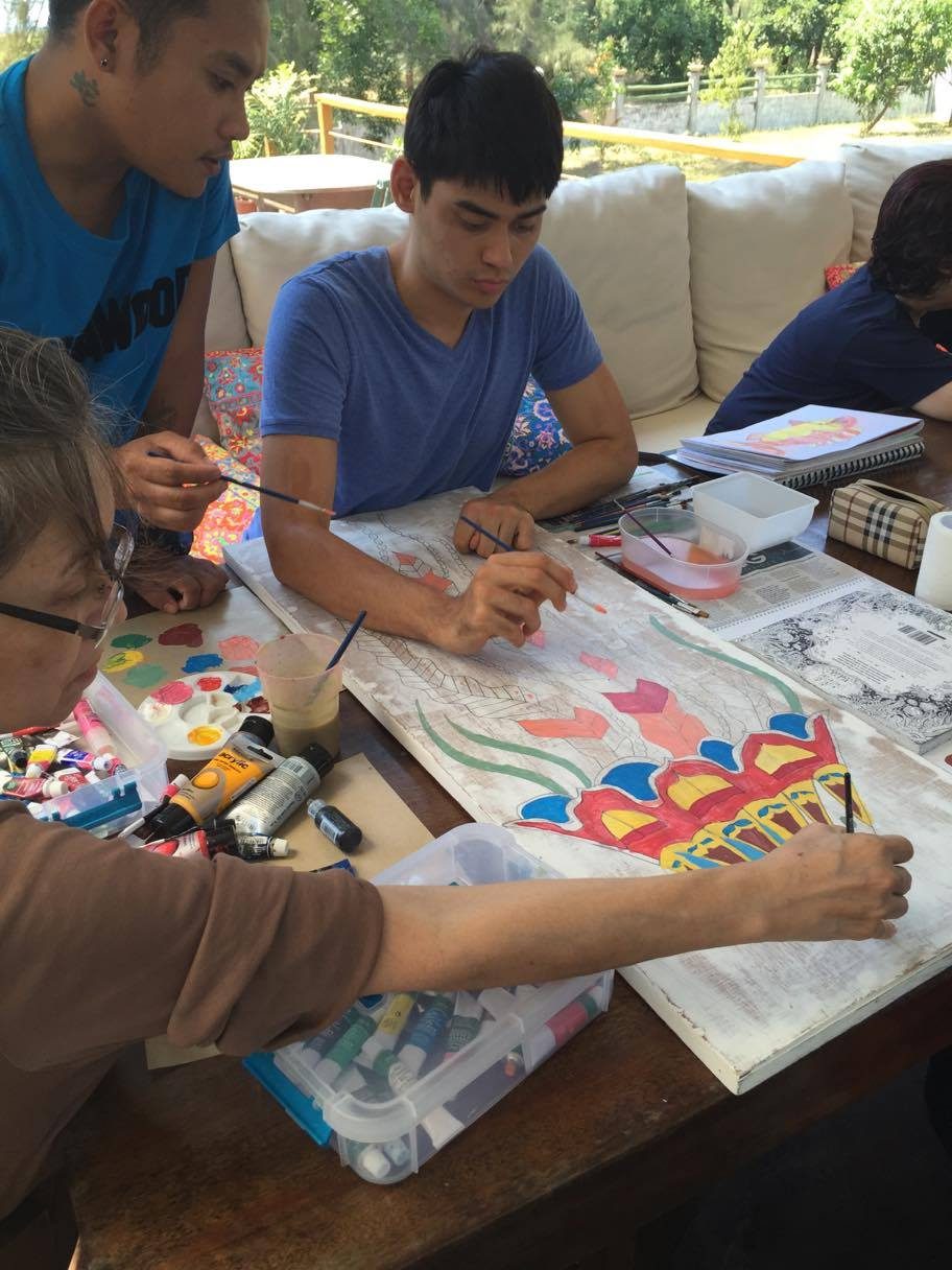 CREATING TOGETHER. Artist with autism Julyan Harrison collaborating with Saturday Group artist Rose Gisbert. Harrison also did the line drawing of the jellyfish. Photo courtesy of Rachel Harrison 