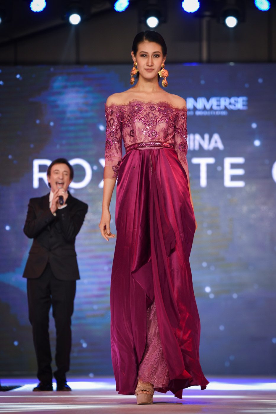 Miss China walks on the runway as David  Pomeranz serenades them 
