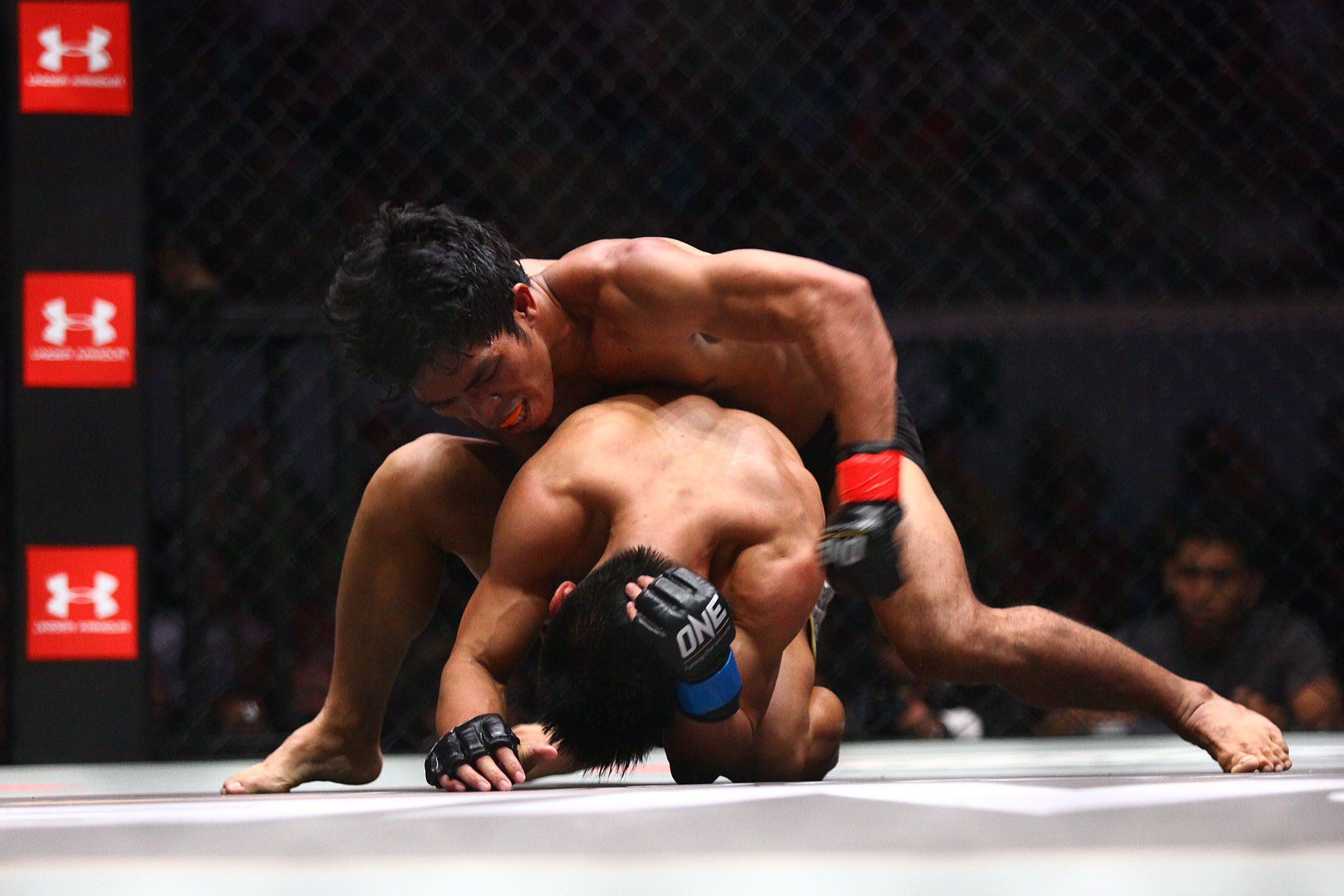 PINOY PRIDE. Filipino Eugene Toquero punches his opponent Li Wei Bin several times in the head. Photo by Josh Albelda/Rappler 