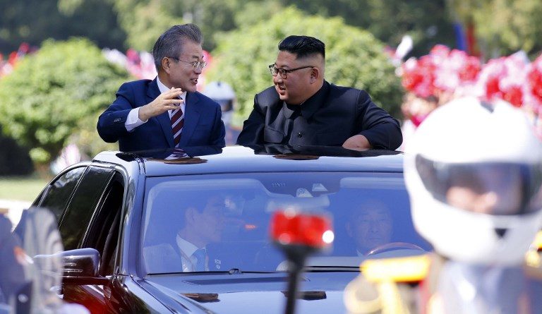 UNITED LEADERS. North Korean leader Kim Jong Un (right) talks with South Korean President Moon Jae-in in an open-topped vehicle as they drive through Pyongyang on September 18, 2018. Photo by Pyeongyang Press Corps/AFP  