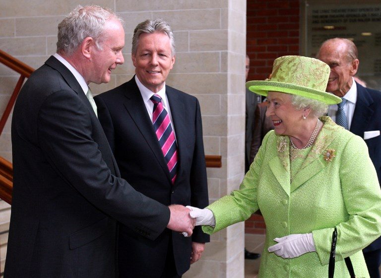 RECONCILIATION. Britain's Queen Elizabeth II (2nd R) shakes hands with Northern Ireland Deputy First Minister Martin McGuinness (L) watched by First Minister Peter Robinson (2nd L) and Prince Philip (R) at the Lyric Theatre in Belfast, Northern Ireland, on June 27, 2012. The initial handshake between the queen and McGuinness took place away from the media spotlight behind closed doors in Belfast's Lyric theatre. File photo by Paul Faith/AFP 