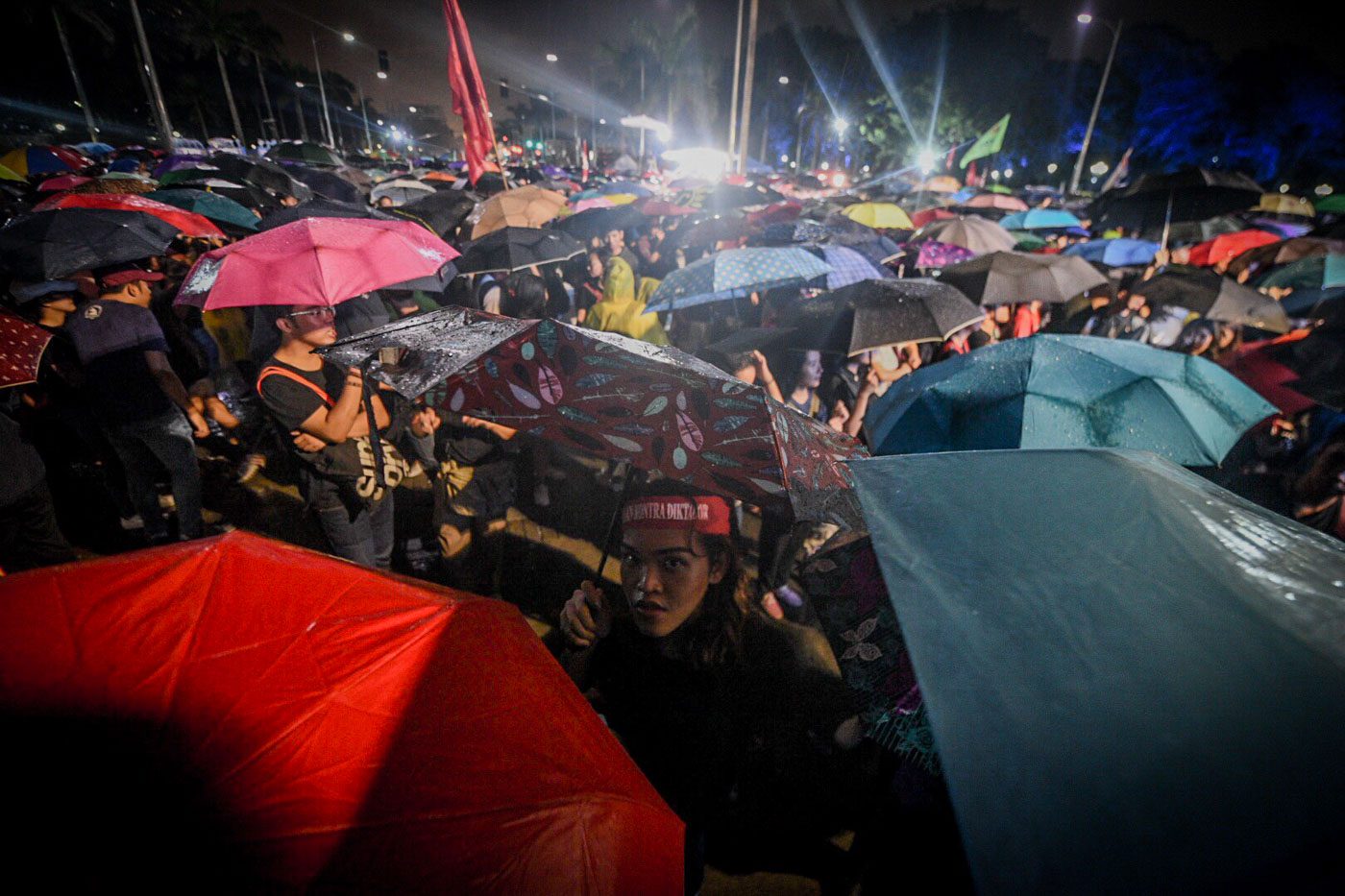 WEATHER RESISTANT. Protesters continue their program despite heavy rains during the 46th anniversary of the declaration of Martial Law on September 21, 2018, in Luneta, Manila. Photo by Alecs Ongcal/Rappler   