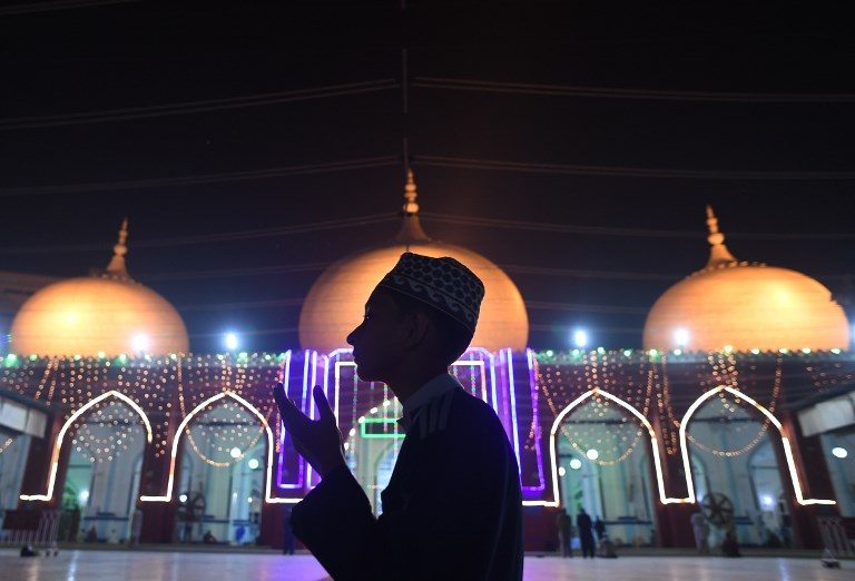 CELEBRATION. A Pakistani Muslim prays at an illuminated mosque in connection with Eid-e-Milad-un-Nabi, the birthday of Prophet Mohammad, in Karachi on November 20, 2018. Photo by Asif Hassan/AFP  