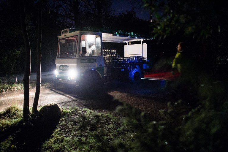 BEFORE DAWN. British milkmen like Neil Garner set out for their deliveries at 2 am. Photo by Leon Neal/AFP 