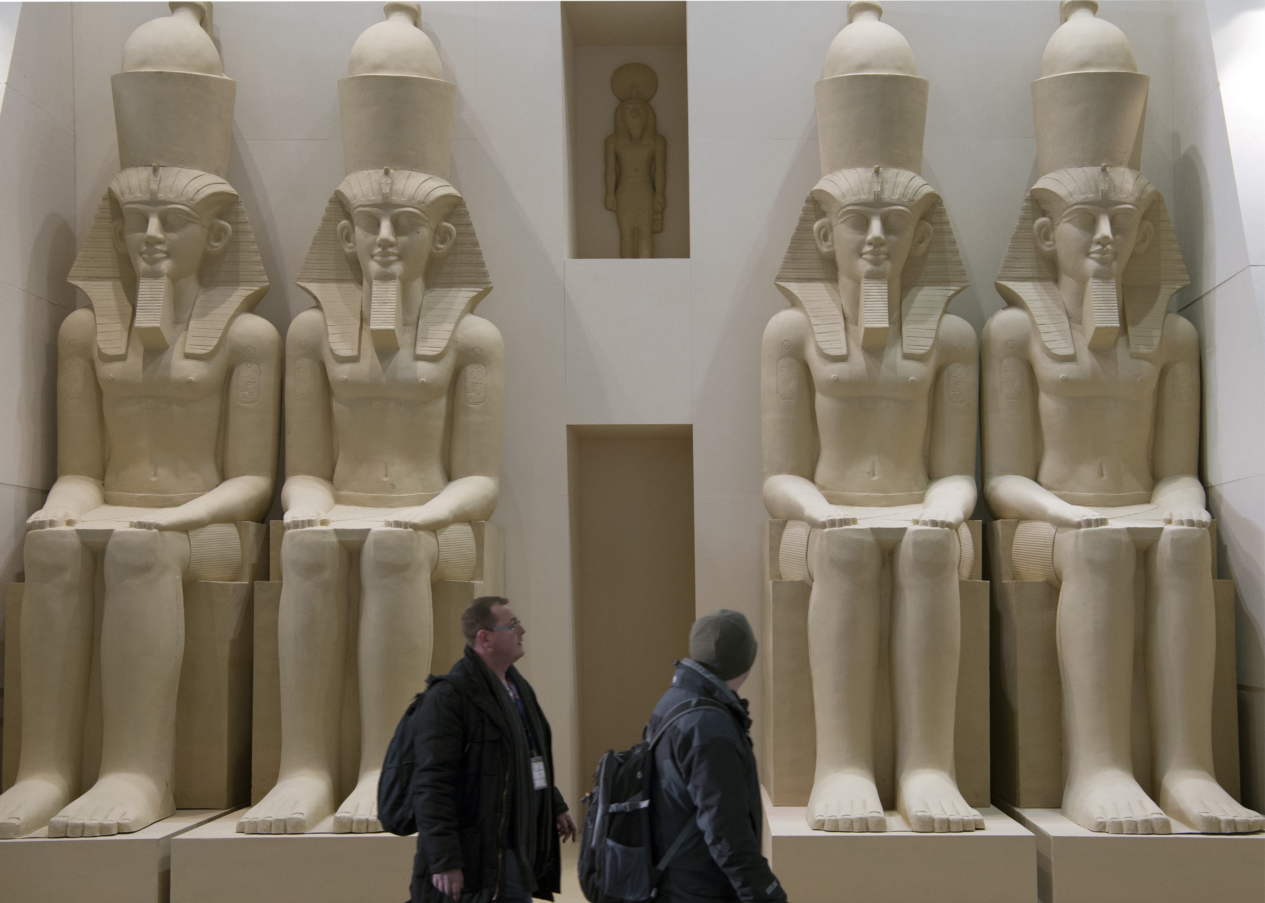 EGYPT BOOTH. Two men walk past statues at the ITB Berlin international travel trade show in Germany, March 9, 2016. Photo by Soeren Stache/EPA 