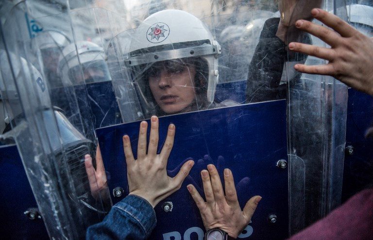 WOMEN VS WOMEN. A Turkish female riot police officer reacts during clashes with women's rights activists as they try to march to Taksim Square to protest against gender violence in Istanbul on November 25, 2018, on the International Day for the Elimination of Violence against Women. Photo by Bulent Kilic/AFP   