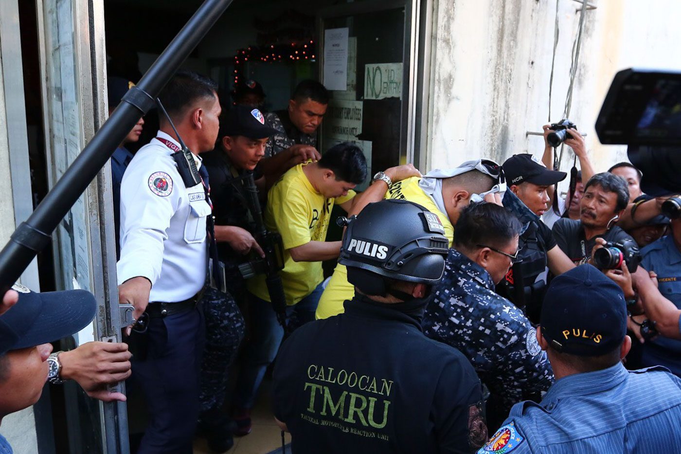 GUILTY. Cops (in yellow shirts) found guilty of murdering Kian delos Santos try to hide their faces as they are led outside the courthouse on November 29, 2018. Photo by Jire Carreon/Rappler   